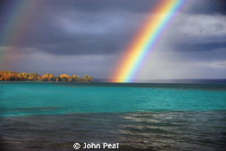 Just shot this Rainbow over Torch Lake. An inland lake in... by John Peal 